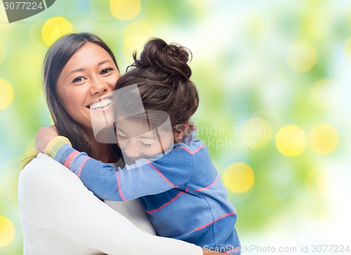 Image of happy mother and daughter hugging