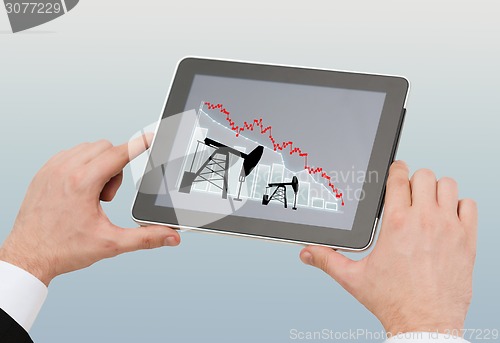 Image of close up of man hands holding tablet pc