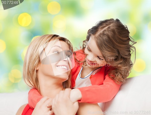 Image of happy mother with daughter hugging and talking