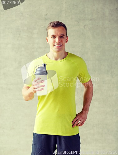 Image of smiling man with protein shake bottle
