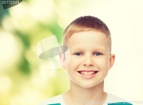 Image of smiling little boy over green background