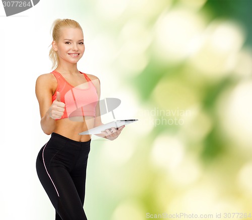 Image of smiling sporty woman with tablet pc computer