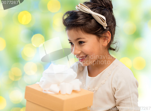 Image of happy little girl with gift box