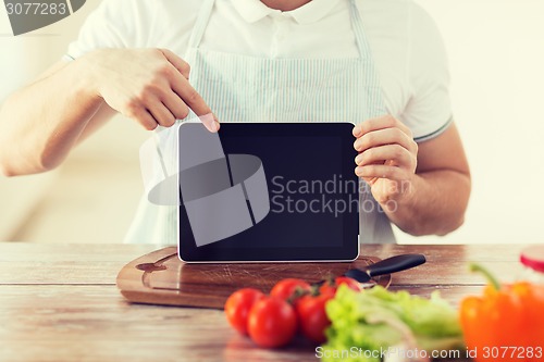 Image of close up of male hands holding tablet pc