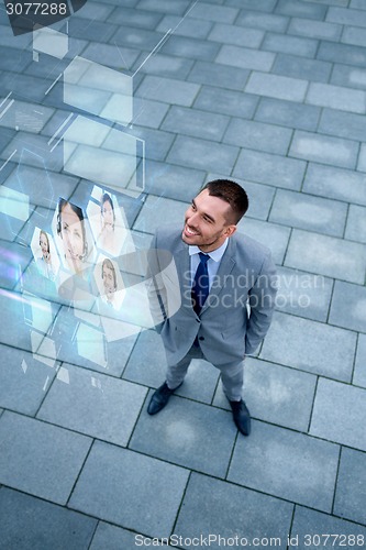 Image of young smiling businessman outdoors from top