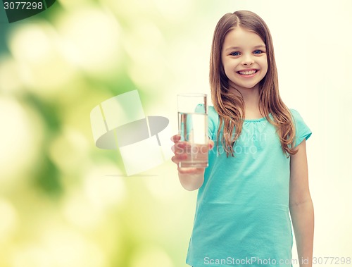 Image of smiling little girl giving glass of water