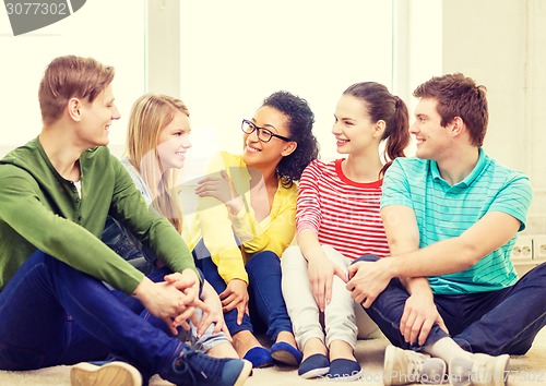 Image of five smiling teenagers having fun at home