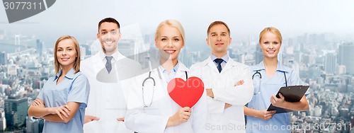 Image of group of smiling doctors with red heart shape