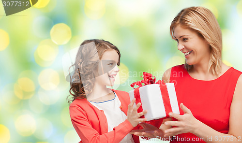 Image of happy mother and daughter with gift box