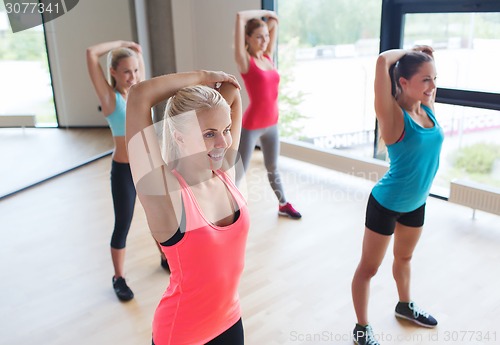 Image of group of happy women working out in gym