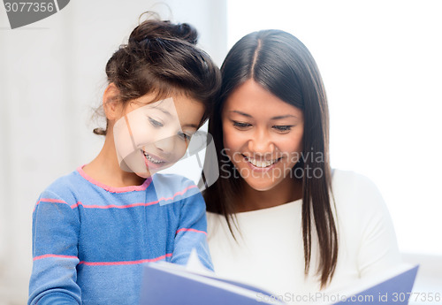 Image of mother and daughter with book