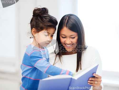 Image of mother and daughter with book