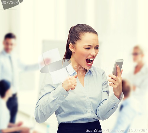 Image of screaming businesswoman with smartphone