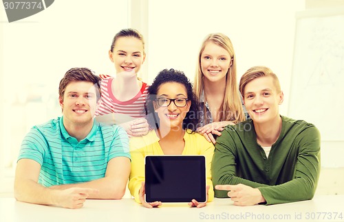 Image of smiling students showing tablet pc blank screen