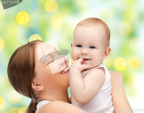 Image of happy mother with baby over green background