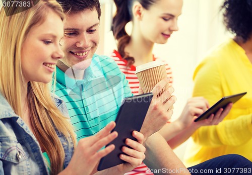 Image of smiling students with tablet pc at school