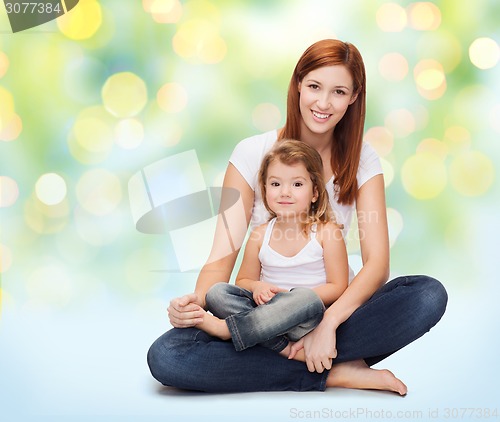 Image of happy mother with little girl over green lights