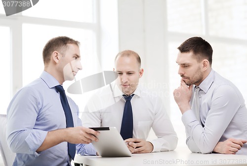 Image of business team working with tablet pc in office