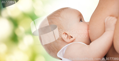 Image of close up of mother breast feeding adorable baby