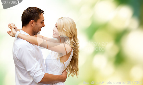 Image of happy couple hugging over green background