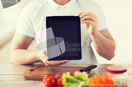 Image of close up of male hands holding tablet pc