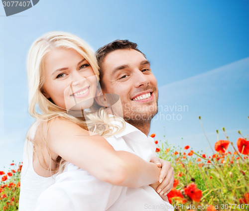 Image of happy couple having fun over poppy flowers field