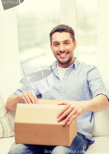 Image of man with cardboard boxes at home