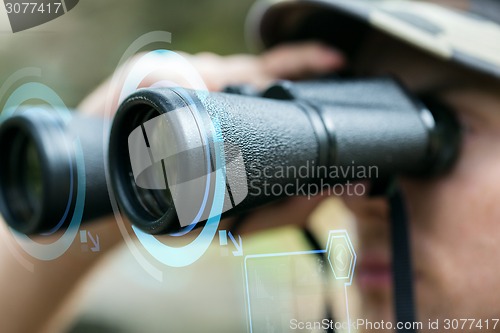 Image of close up of soldier or hunter with binocular