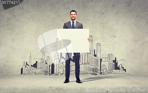 Image of smiling businessman with white blank board