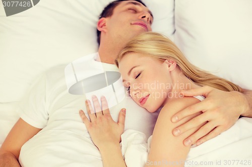 Image of happy couple sleeping in bed