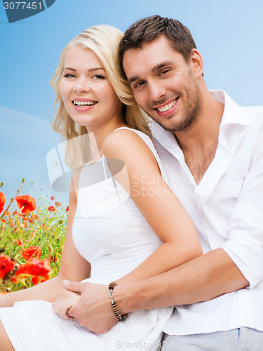 Image of happy couple having fun over poppy flowers field