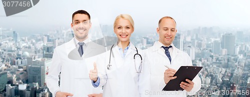 Image of group of doctors showing thumbs up over white