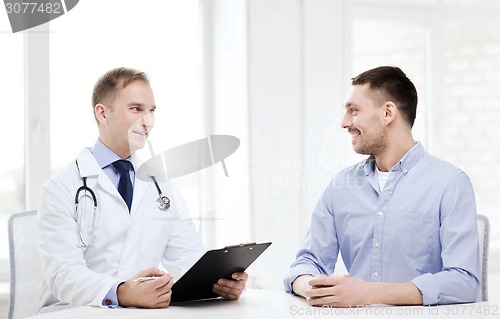 Image of doctor with clipboard and patient in hospital