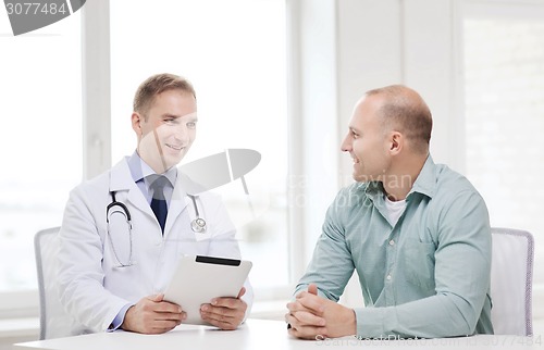 Image of doctor with tablet pc and patient in hospital