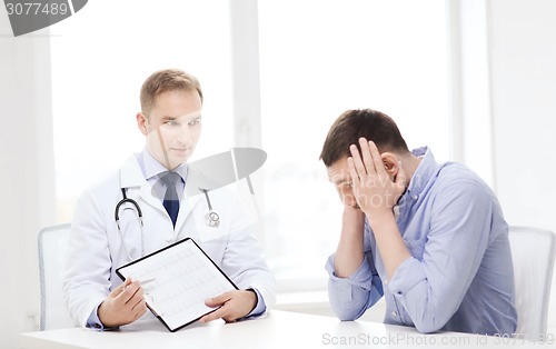 Image of doctor with clipboard and patient in hospital