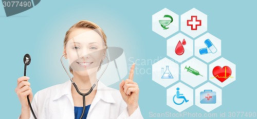 Image of smiling doctor over medical icons blue background