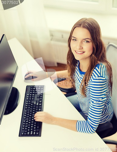 Image of dreaming teenage girl with computer at home