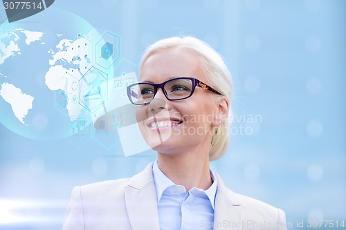 Image of young smiling businesswoman in eyeglasses outdoors