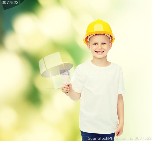 Image of smiling little boy in helmet with paint brush