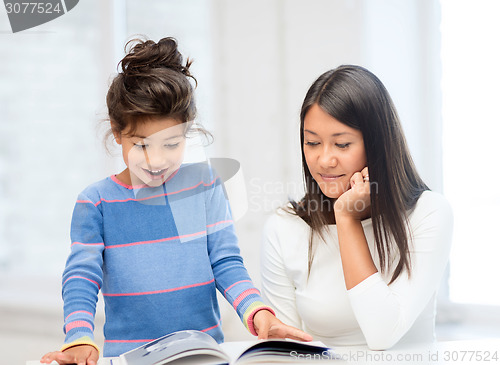 Image of mother and daughter with book