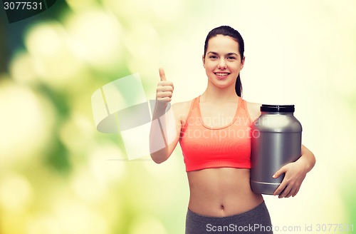 Image of teenage girl with jar of protein showing thumbs up