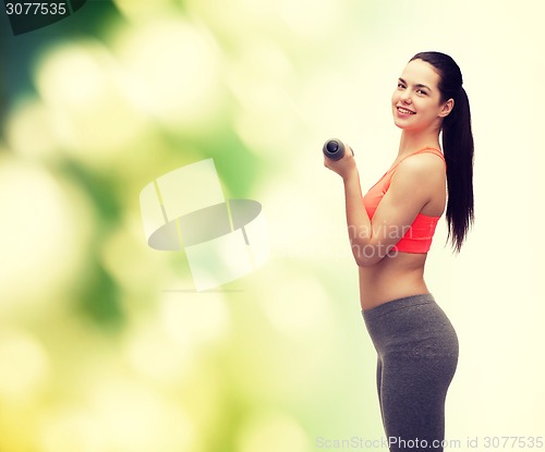 Image of young sporty woman with light dumbbells