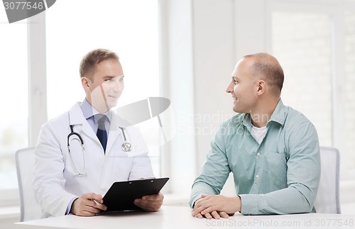 Image of doctor with clipboard and patient in hospital