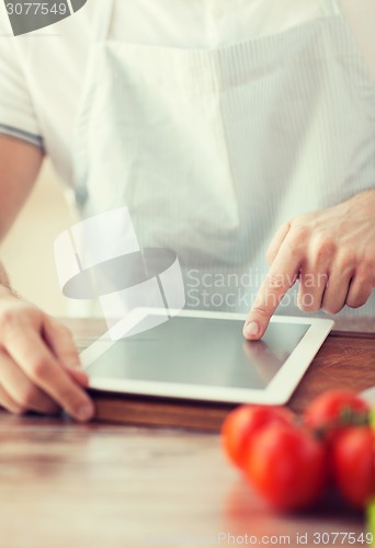 Image of closeup of man pointing finger to tablet pc