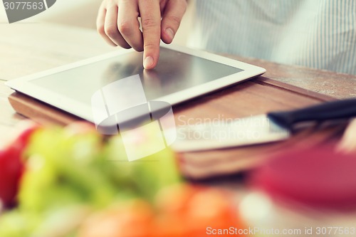 Image of closeup of man pointing finger to tablet pc