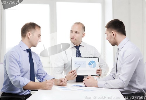 Image of serious businessmen with papers in office