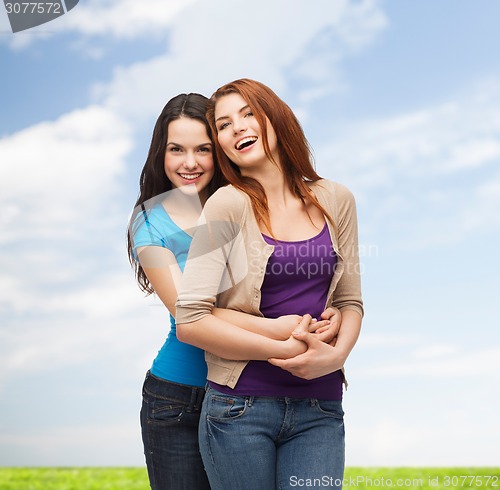 Image of smiling teenage girls hugging