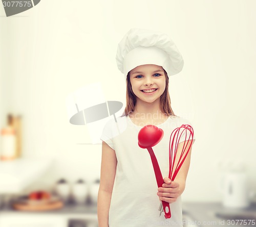 Image of smiling girl in cook hat with ladle and whisk