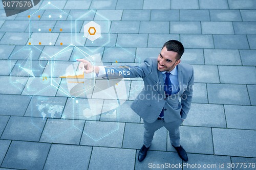 Image of young smiling businessman outdoors from top