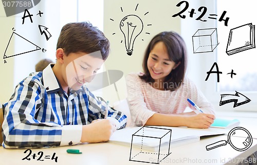 Image of group of school kids writing test in classroom